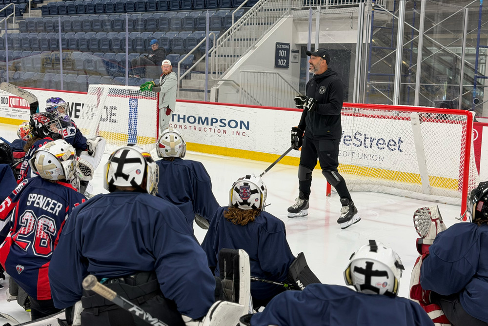 Ian Keserich coaching from the net during a camp session